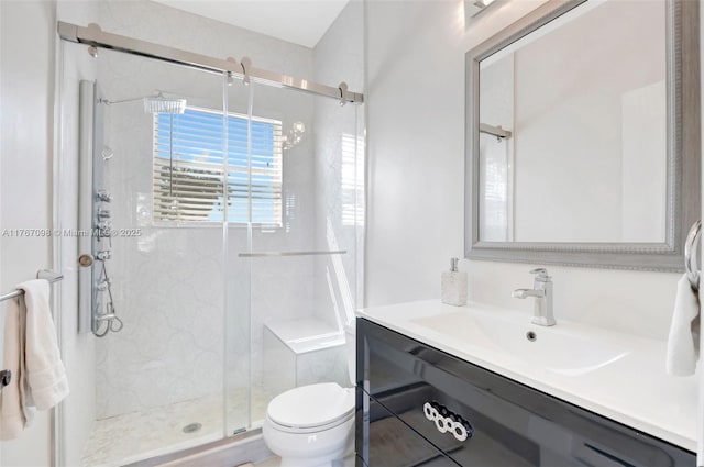 full bathroom featuring a marble finish shower, toilet, and vanity
