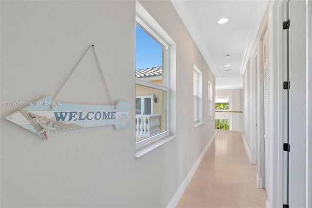 hall featuring recessed lighting, light wood-type flooring, and baseboards