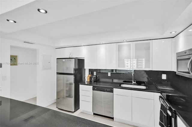 19370 Collins Ave Unit 1504, Sunny Isles Beach, FL 33160 - kitchen featuring white cabinets, dark countertops, a sink, stainless steel appliances, and modern cabinets