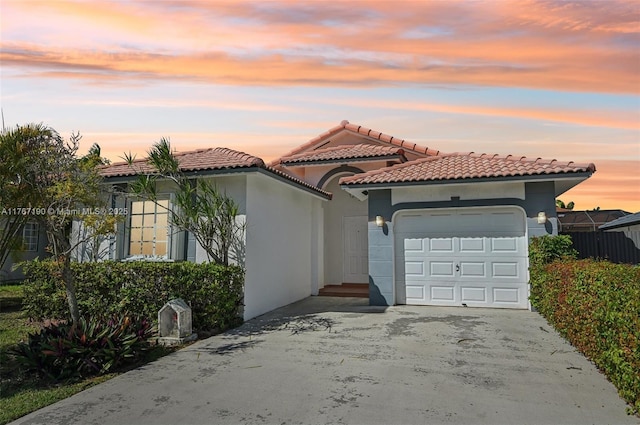18234 SW 143rd Pl, Miami, FL 33177 - mediterranean / spanish-style home with a tiled roof, stucco siding, driveway, and a garage