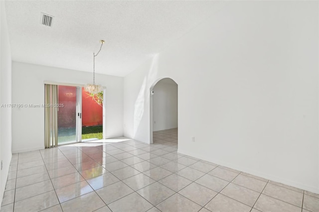 18234 SW 143rd Pl, Miami, FL 33177 - spare room featuring a notable chandelier, light tile patterned flooring, arched walkways, and visible vents