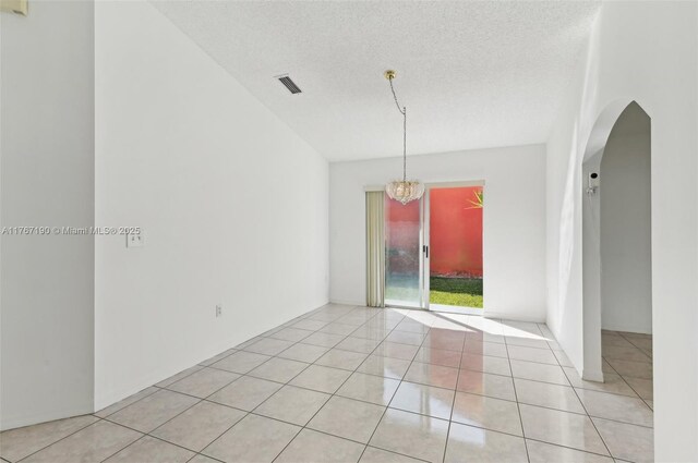 18234 SW 143rd Pl, Miami, FL 33177 - unfurnished room with light tile patterned flooring, visible vents, arched walkways, and a textured ceiling