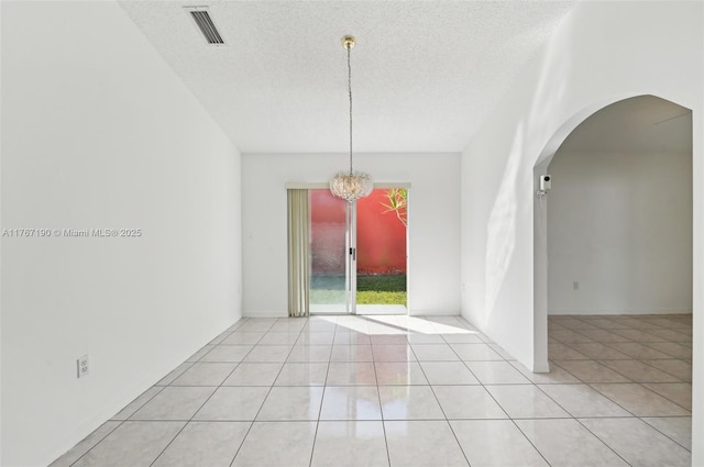 18234 SW 143rd Pl, Miami, FL 33177 - spare room with light tile patterned floors, visible vents, an inviting chandelier, arched walkways, and a textured ceiling