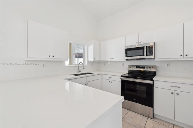 18234 SW 143rd Pl, Miami, FL 33177 - kitchen with a sink, stainless steel appliances, white cabinets, light tile patterned flooring, and light countertops