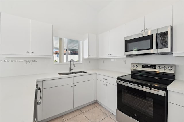 18234 SW 143rd Pl, Miami, FL 33177 - kitchen featuring light countertops, appliances with stainless steel finishes, light tile patterned flooring, white cabinets, and a sink