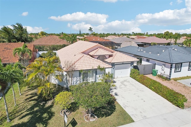 18234 SW 143rd Pl, Miami, FL 33177 - view of front of house featuring fence, concrete driveway, a tile roof, stucco siding, and an attached garage