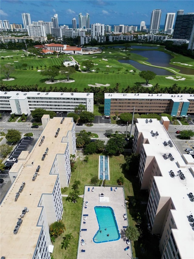 aerial view with a view of city, view of golf course, and a water view