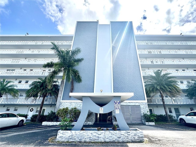 view of building exterior with uncovered parking