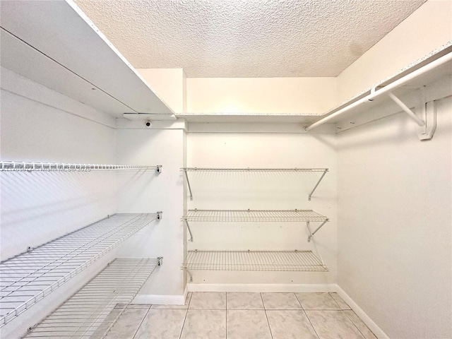 walk in closet featuring tile patterned flooring