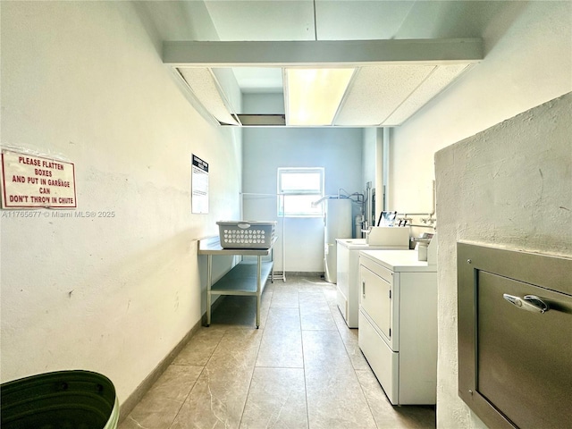 shared laundry area featuring water heater, independent washer and dryer, and light tile patterned flooring