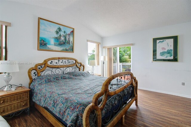 bedroom featuring baseboards, access to outside, wood finished floors, and lofted ceiling