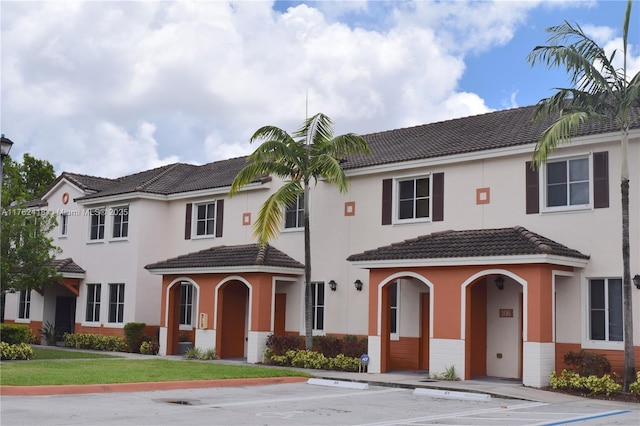 17347 NW 7th Ave Unit 907, Miami Gardens, FL 33169 - view of front of property with uncovered parking, stucco siding, and a tile roof