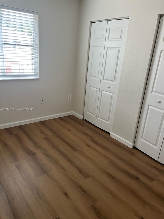 17347 NW 7th Ave Unit 907, Miami Gardens, FL 33169 - unfurnished bedroom with a closet, baseboards, and wood finished floors
