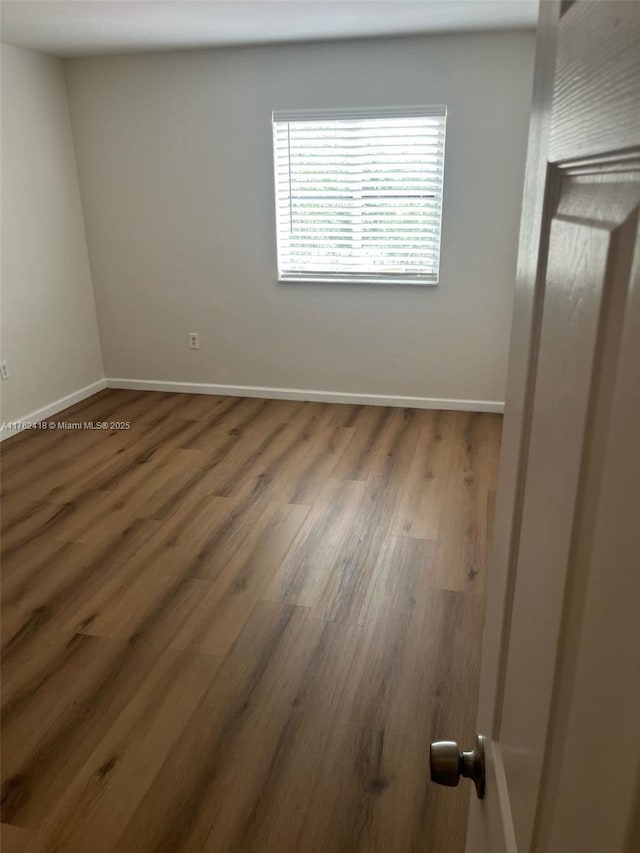 17347 NW 7th Ave Unit 907, Miami Gardens, FL 33169 - unfurnished bedroom with baseboards and wood finished floors