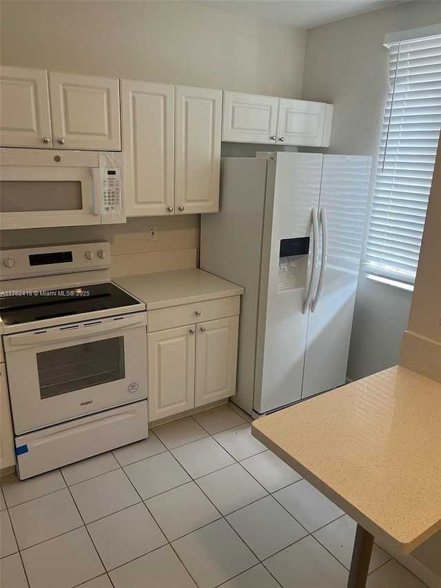 17347 NW 7th Ave Unit 907, Miami Gardens, FL 33169 - kitchen with light tile patterned flooring, light countertops, white appliances, and white cabinets