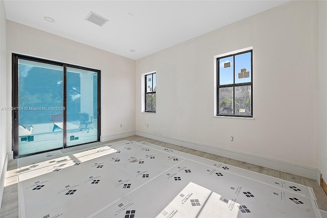 unfurnished room with baseboards