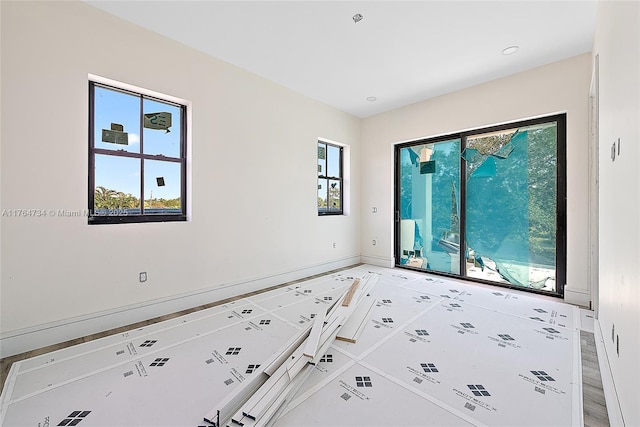 unfurnished room featuring baseboards