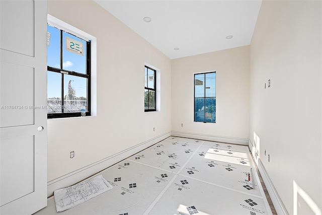 spare room featuring baseboards