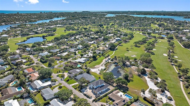 aerial view of property's location with a large body of water, nearby suburban area, and a local golf course