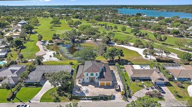 view of property location with a nearby body of water, a golf club, and nearby suburban area