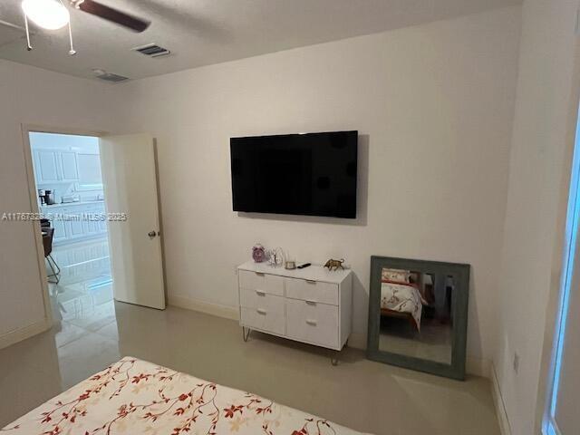 bedroom featuring visible vents, baseboards, and a ceiling fan