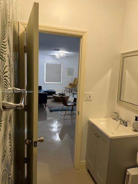 bathroom with tile patterned floors and vanity