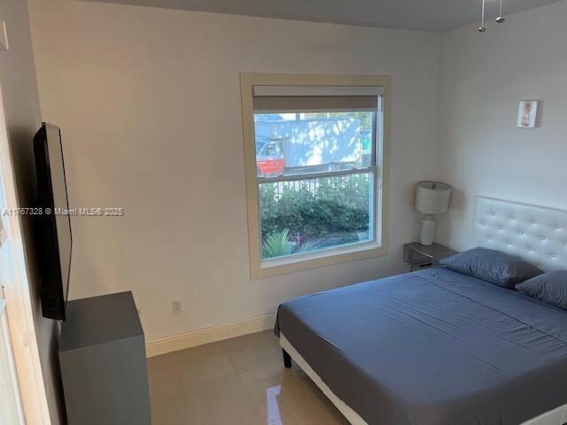 bedroom featuring baseboards