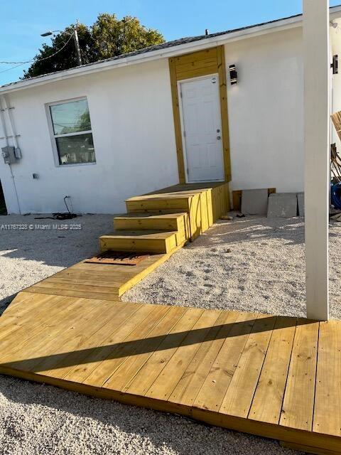 entrance to property featuring stucco siding