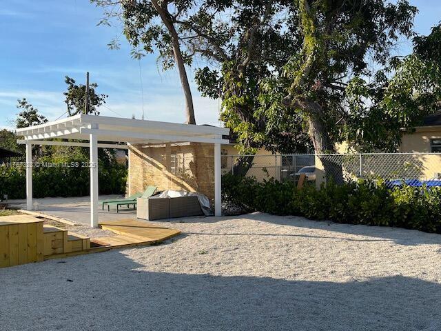 exterior space with a patio area, a pergola, and fence