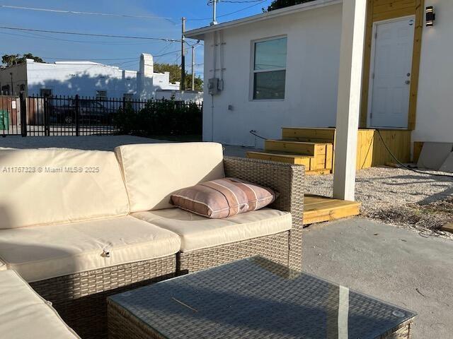 view of patio / terrace featuring an outdoor living space and fence