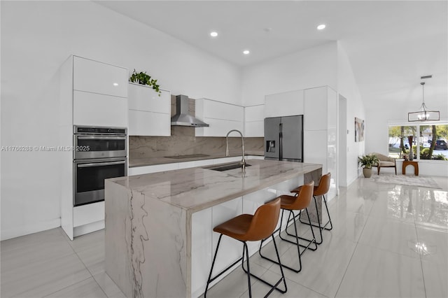 710 Lake Blvd, Weston, FL 33326 - kitchen featuring a sink, modern cabinets, fridge with ice dispenser, white cabinetry, and wall chimney range hood