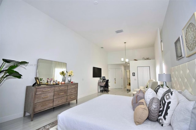 710 Lake Blvd, Weston, FL 33326 - bedroom with a high ceiling, baseboards, and light wood-style flooring