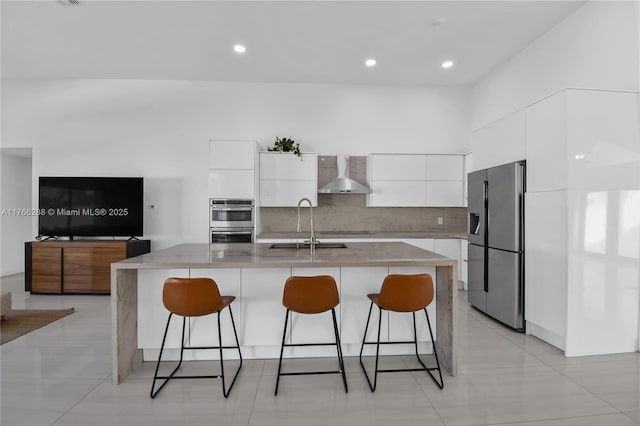 710 Lake Blvd, Weston, FL 33326 - kitchen featuring appliances with stainless steel finishes, wall chimney exhaust hood, modern cabinets, white cabinets, and recessed lighting