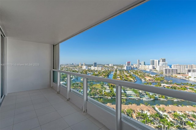 balcony featuring a water view and a city view