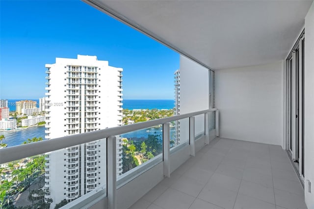 balcony with a water view and a city view