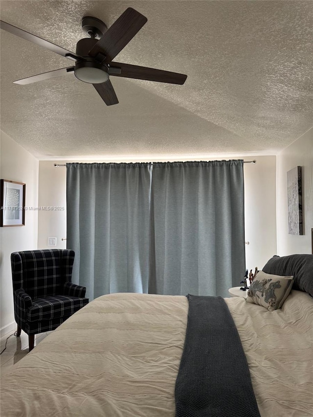 bedroom with a textured ceiling and ceiling fan