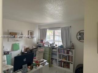 office area with a textured ceiling