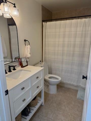 bathroom featuring vanity, toilet, tile patterned floors, and a shower with shower curtain