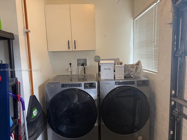 laundry area featuring independent washer and dryer and cabinet space