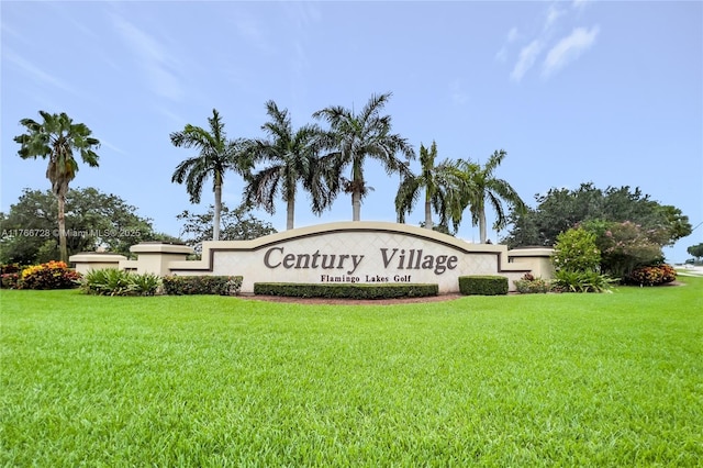 community / neighborhood sign featuring a yard