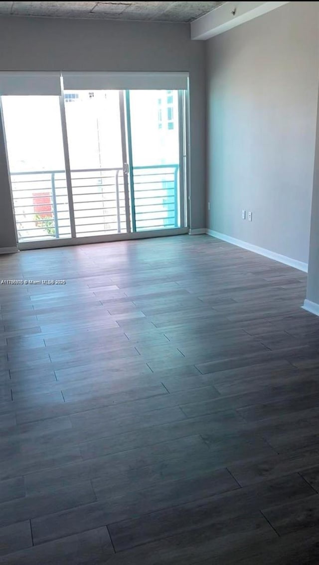 133 NE 2nd Ave Unit 1409, Miami, FL 33132 - empty room with dark wood-style floors and baseboards
