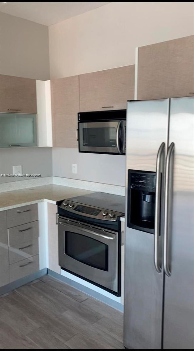 133 NE 2nd Ave Unit 1409, Miami, FL 33132 - kitchen featuring stainless steel appliances, modern cabinets, gray cabinetry, and light countertops