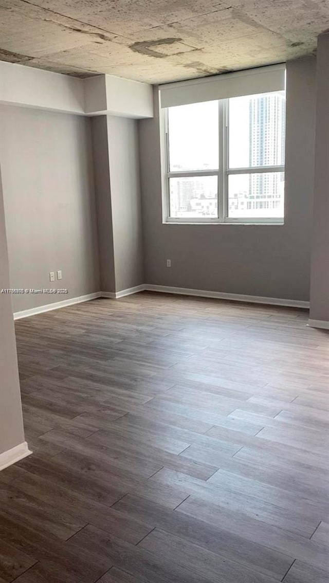 133 NE 2nd Ave Unit 1409, Miami, FL 33132 - unfurnished room featuring baseboards and wood finished floors