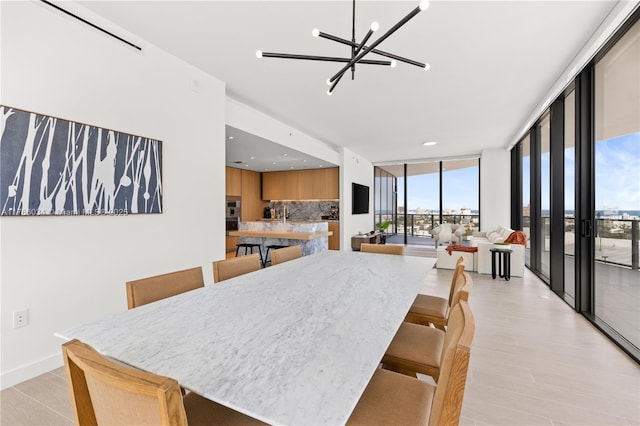500 Alton Rd Unit 1201, Miami Beach, FL 33139 - dining room with floor to ceiling windows, light wood-type flooring, recessed lighting, and a notable chandelier