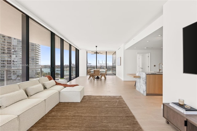 500 Alton Rd Unit 1201, Miami Beach, FL 33139 - living room featuring a notable chandelier, light wood finished floors, a water view, and floor to ceiling windows