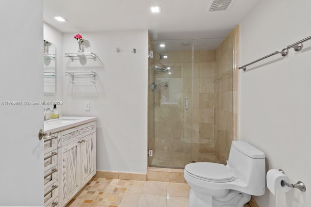 full bathroom featuring toilet, a shower stall, vanity, baseboards, and tile patterned floors
