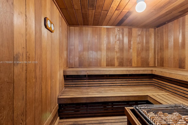 sauna / steam room featuring wood ceiling and wood walls