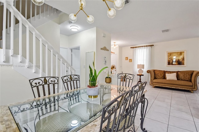 tiled dining space with stairs and visible vents