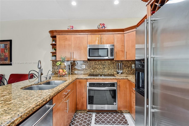 kitchen with open shelves, light stone counters, a sink, stainless steel appliances, and backsplash