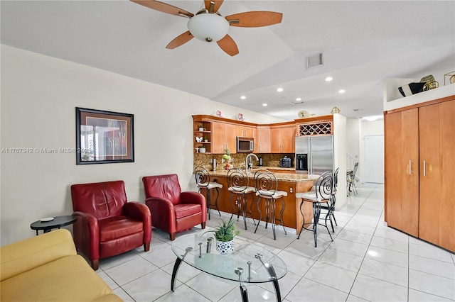 living room featuring ceiling fan, recessed lighting, light tile patterned floors, vaulted ceiling, and visible vents